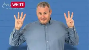 A male figure Mr. James White with his hands up showing 4 on his right rand, and 3 on his left hand indicating decision